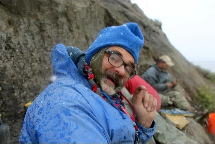 JP Cavigelli of the Tate Geological Museum in Wyoming holds up a tiny fossil. (Credit: Jaelyn Eberle)
